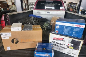 Boxes of car parts in a truck bed